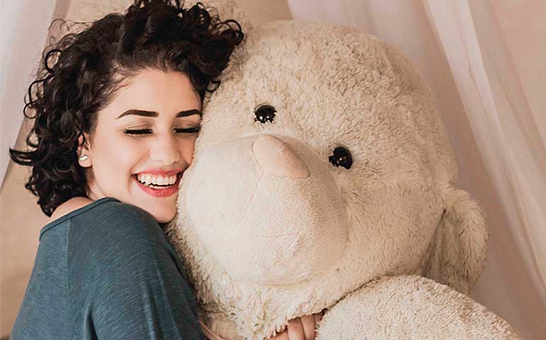 Girl cuddling a buddy softie