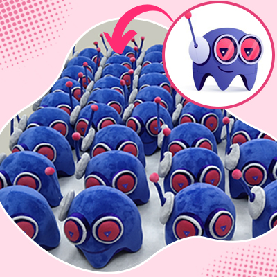 Bulk promotional plush: pixel‑style blue handheld game character with smile and yellow buttons.